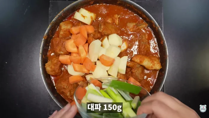 Add hard vegetables like potatoes and carrots.