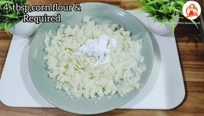 Add cornflour, chopped spring onion, and salt to the mashed potatoes. Mix well to form a soft dough.
