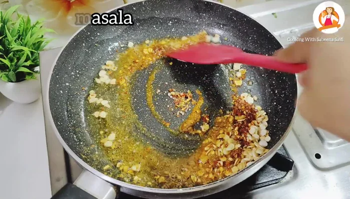 Add the spice mixture to the garlic and fry lightly.