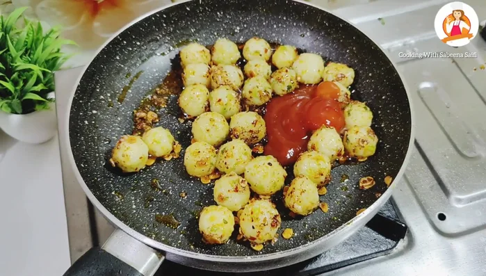 Add soy sauce, tomato ketchup, lemon juice, and fresh coriander. Mix well.