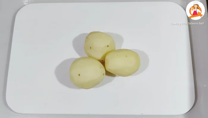 Peel and roughly chop three medium-sized potatoes.