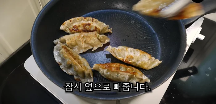 Roll the dumplings back and forth until crispy, then set aside.