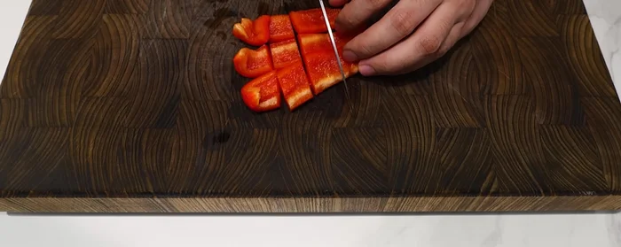 Cut onions and bell peppers into bite-sized pieces and place them on top of the beef.