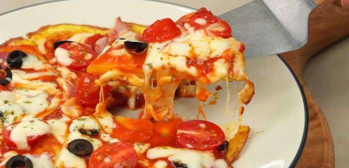 Add pizza sauce and cheese, and any other desired toppings. (Details not provided in transcript)