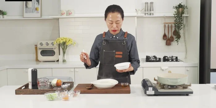 Add cooked rice to the pan, mixing with the egg mixture. Drizzle with sesame oil for added flavor.