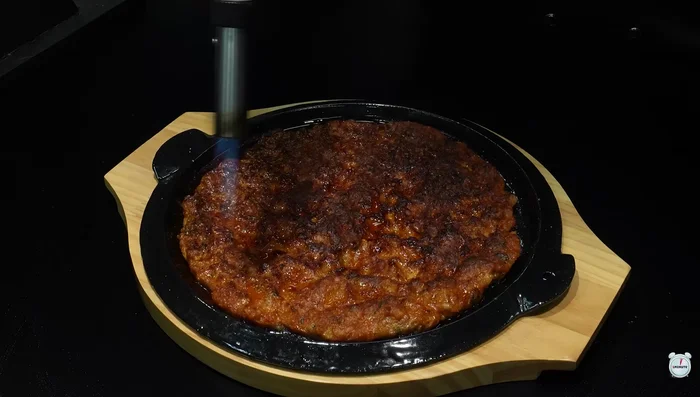 Lightly sear the surface with a kitchen torch.