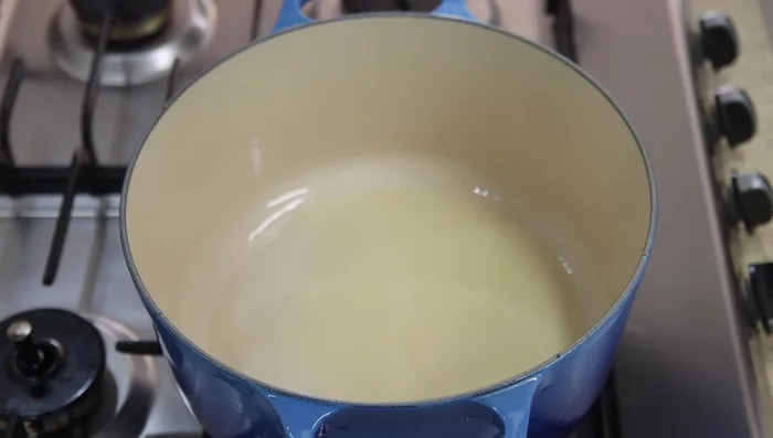 In a pot, heat oil over medium-high heat. Sear chicken skin-side down for 2 minutes, then flip and cook for 3 minutes.