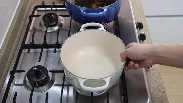 Remove chicken. If using a non-stick pot, transfer chicken fat to a clean pot. Add garlic, onion, and white parts of green onions; sauté for 3 minutes.