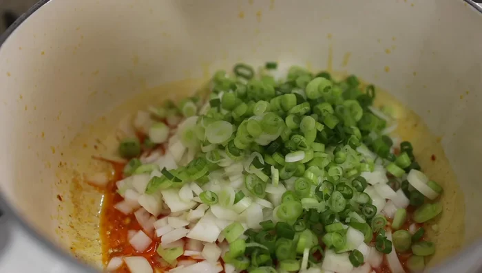 Add drained rice and stir for 1 minute to coat with oil. Pour in seasoned water (1:1 rice to water ratio, plus 1 tbsp chicken bouillon/stock).