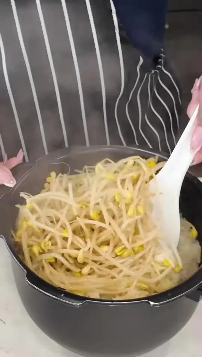 Once the rice is cooked, mix well to incorporate the soybean sprouts.