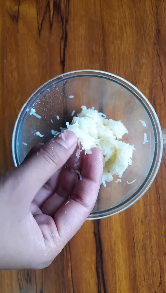 Peel and grate a potato.