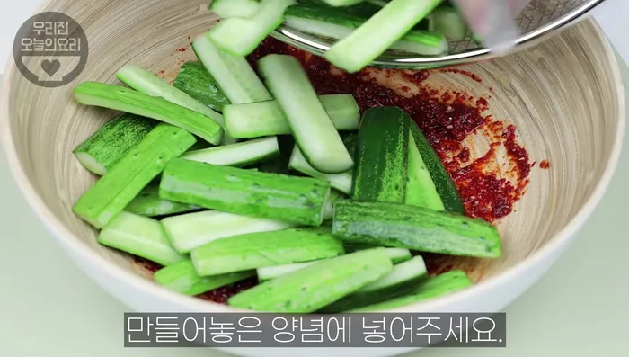 Add the drained cucumbers, chives, and carrots to the seasoning. Mix well. Adjust salt to taste.