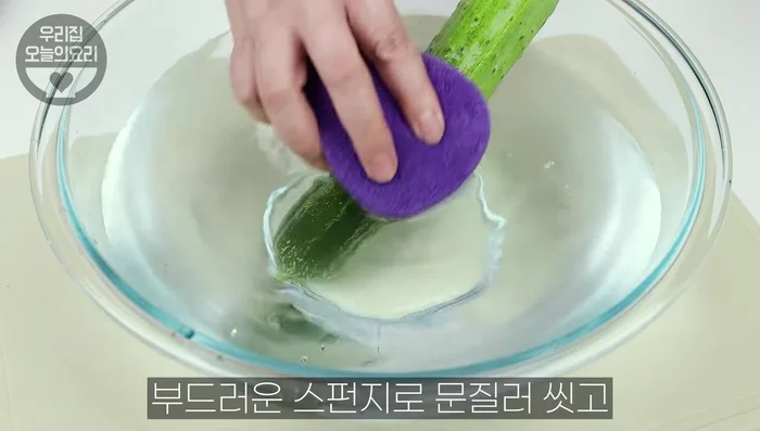 Wash cucumbers thoroughly. Rub with a soft sponge under running water, sprinkle with coarse salt, rub, and rinse to remove pesticides.