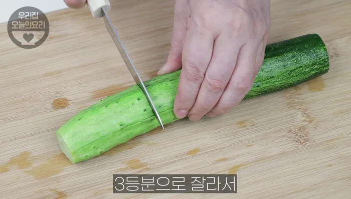 Cut off the ends of the cucumbers, and cut them into thirds, then quarters.