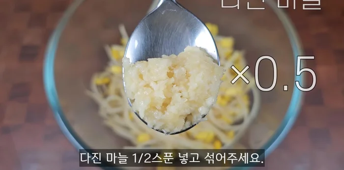 Add 1/2 spoon of minced garlic and mix well.