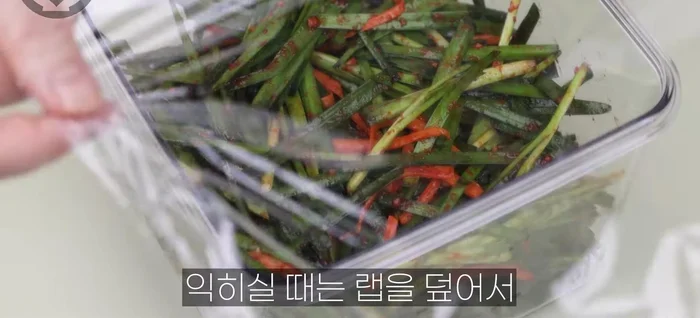 Cover the container with plastic wrap to prevent air contact, then loosely cover with a lid to allow gas to escape during fermentation.