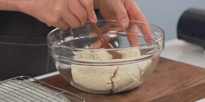 Crumble the tofu in a bowl, season with salt and pepper. Use good quality tofu for best results.