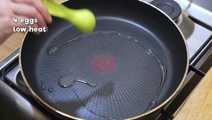 Cook eggs over low heat until whites are set, yolks runny.