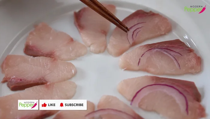 Add toppings: Place a slice of red onion and a jalapeno slice on each Yellowtail piece. Top with masago.
