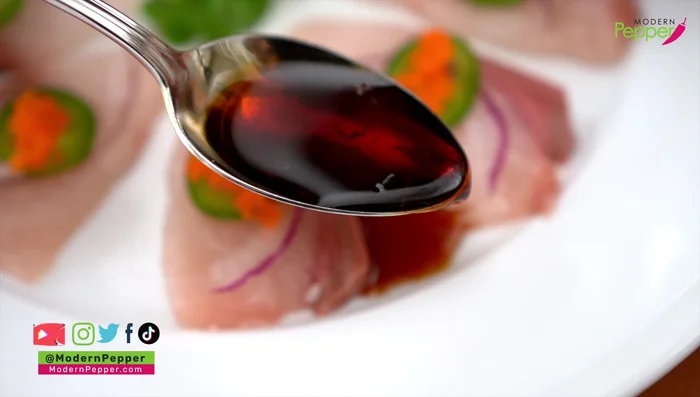 Drizzle sauce: Drizzle the chilled sauce between the sashimi slices.