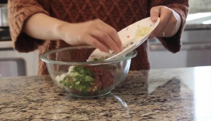 Combine ground beef with the prepared vegetables. Mix well.