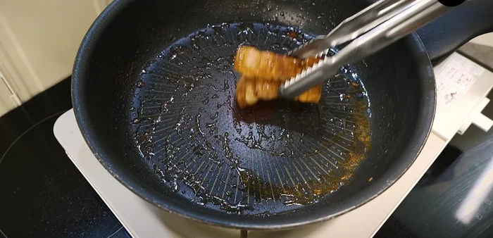 Set aside the pork belly. Add finely chopped green onions to the remaining oil in the pan (add cooking oil if needed). Stir-fry the green onions.