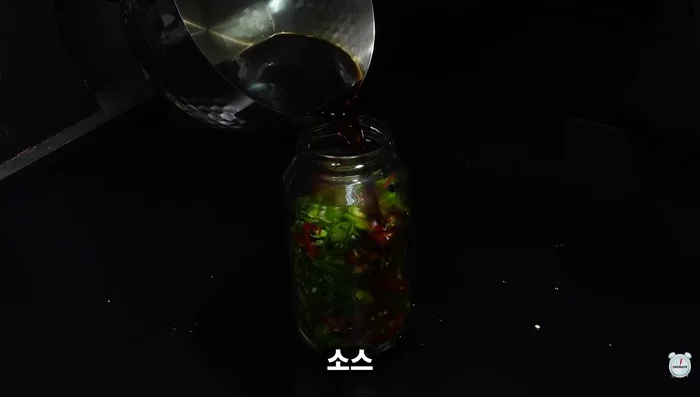 Place the green chili peppers in a bottle and pour the hot sauce over them. Refrigerate for at least half a day.