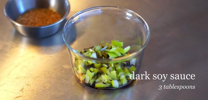 Prepare the sauce: Chop green onion and combine it with dark soy sauce, light soy sauce, sesame seeds, gochugaru, and water. Mix well and add sesame oil.