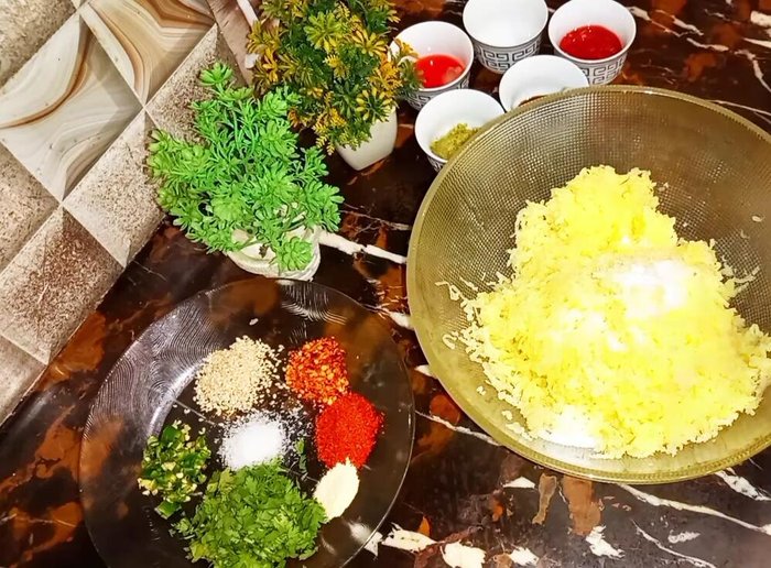 Add 1 teaspoon salt, 4 tablespoons corn flour to the grated potatoes. Mix well to form a soft dough. Add more corn flour if needed to achieve desired consistency.