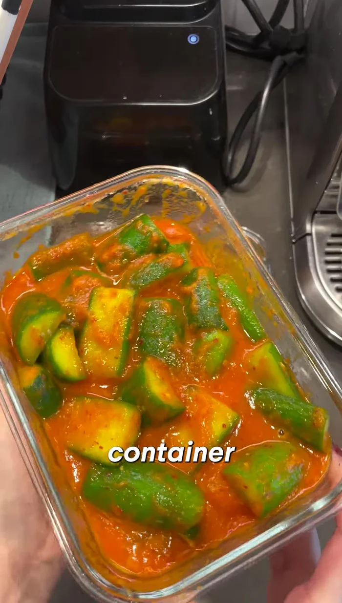 Combine and ferment: Place the drained cucumbers in a glass container. Pour the prepared paste over the cucumbers, ensuring they are well coated.