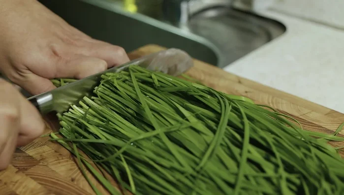 Slice the chives into short lengths and fold them in.