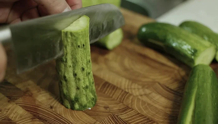 Slice the cucumbers and score a deep cross so they can be stuffed later.