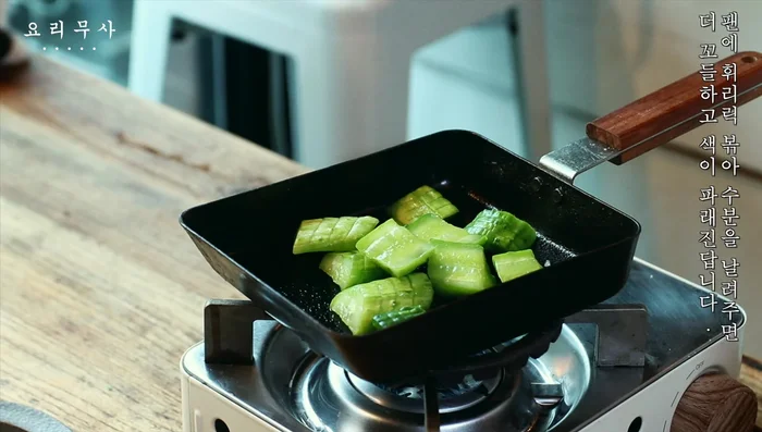 Gently stir-fry the cucumbers to remove excess moisture and enhance their crunchiness and color.
