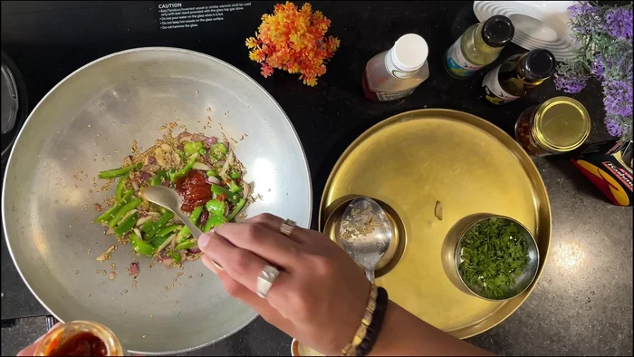 Add Schezwan chutney (adjust amount to your spice preference), tomato ketchup, vinegar, soy sauce, salt, sugar, and a little water to create the sauce.