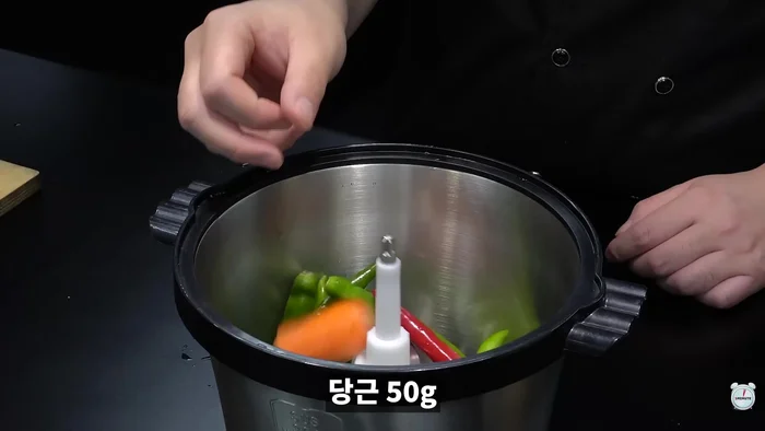 Put the green chili peppers and carrots in an electric mixer and chop them finely.