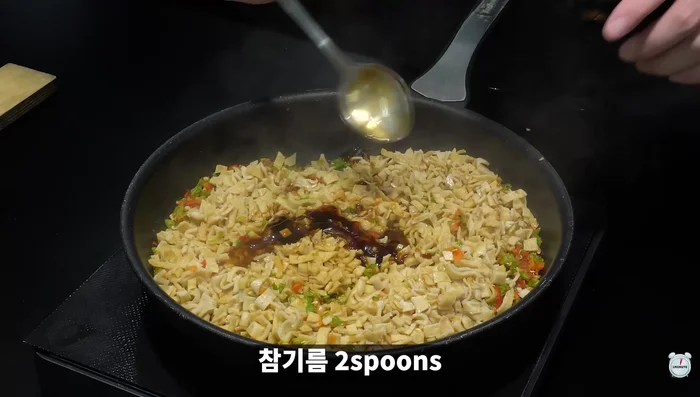 Stir-fry the bulgogi (presumably, based on context) with sesame oil, sesame seeds, and garlic.
