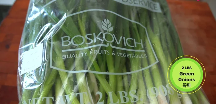 Prepare green onions: Cut off root ends, trim bruised parts, and rinse thoroughly in cold water. Place them upside down in a container, root ends submerged in water.