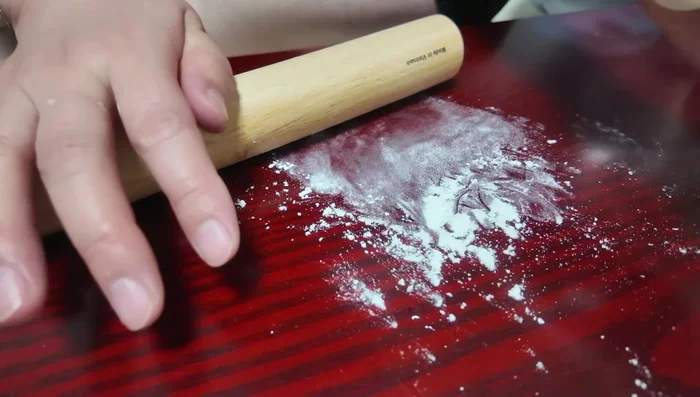 Shape the dumplings: Roll each piece into a circle. Place a spoonful of the filling in the center. Pinch the edges to seal, creating a half-moon shape.