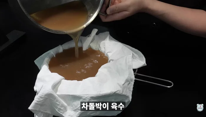 Strain the cooled broth through cheesecloth to remove oil and impurities.