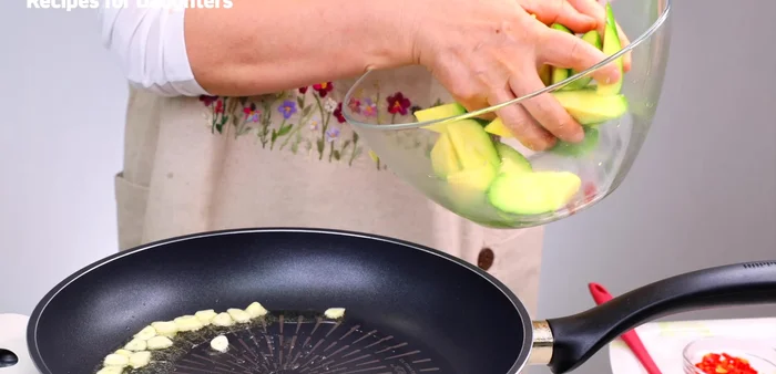 Add the pickled pumpkin (drained) and onions to the pan. Stir-fry until the oil is well absorbed.