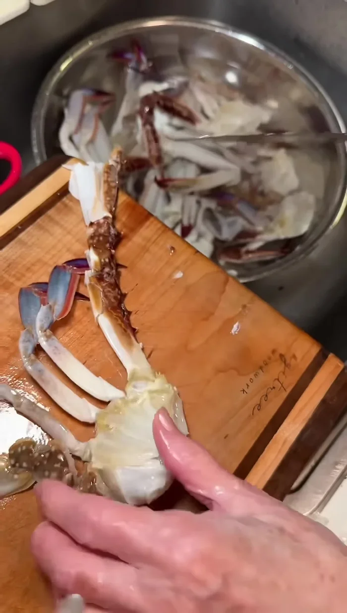 Crack the larger crab claws using the back of your knife.