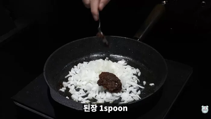 Add chopped onion, soybean paste, soy sauce, chopped garlic, and sugar to the pan.