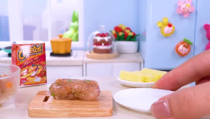 Roll the seasoned chicken into drumstick shapes.
