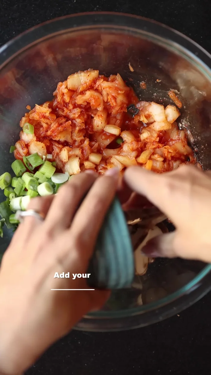 Add your chopped veggies, a little bit of sugar, the pancake mix, and a little bit of ice cold water to the bowl.