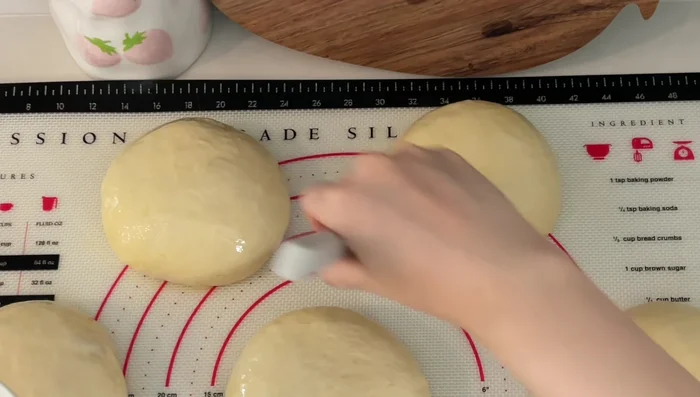 Brush with egg wash, transfer to a baking pan, and bake at 350°F for 35-45 minutes.