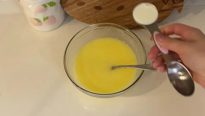 Make garlic butter by combining melted butter, egg, heavy cream, milk, honey, minced garlic, and parsley. The texture should be thick but pourable.