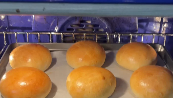 Once buns are slightly cool, slice into six sections (don't cut all the way through). Pipe cream cheese filling into each slit.