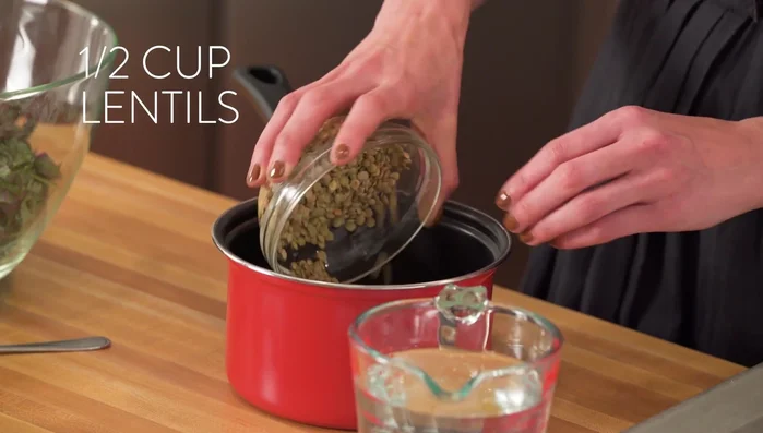 Wash lentils and place them in a saucepan. Add 2 cups of water or vegetable broth, a bay leaf, and a pinch of salt. Simmer for 20-25 minutes.