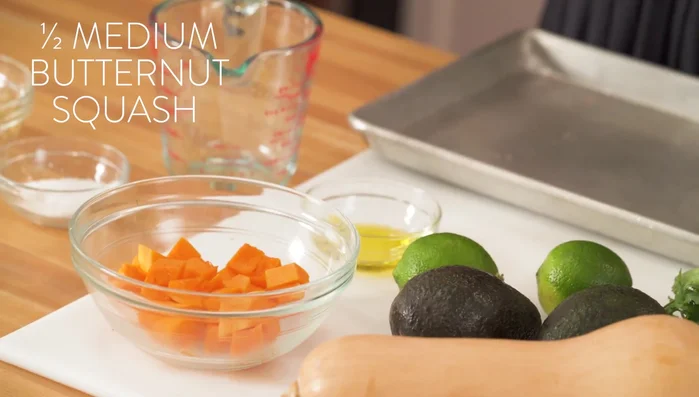 Dice butternut squash into 1-2 inch pieces. Toss with olive oil.