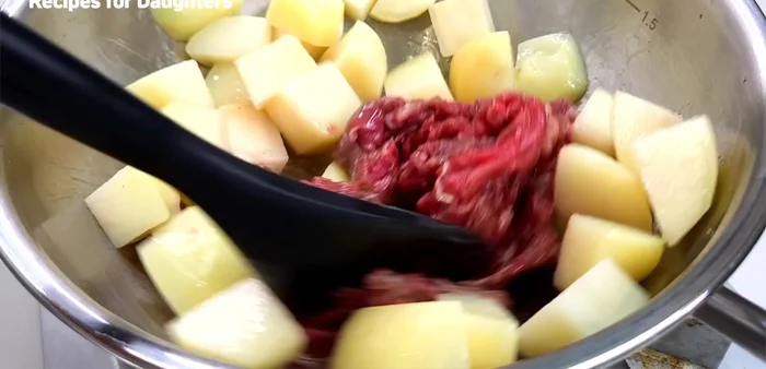 Add the beef and stir-fry until slightly cooked and browned.